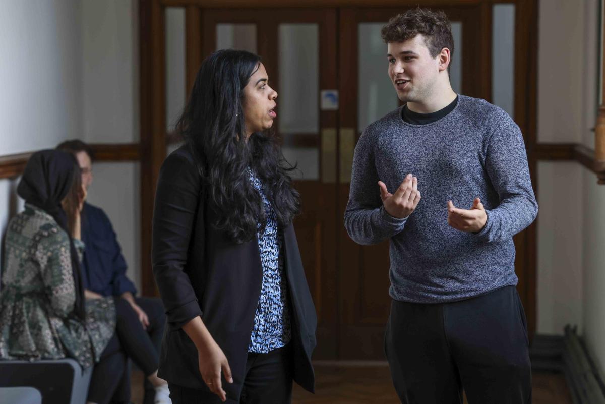 2 people having a conversations standing up