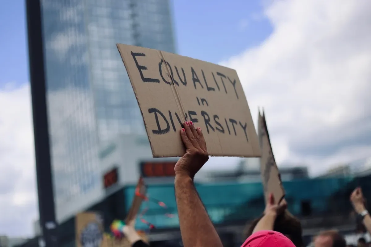 Someone holding up an Equality is Diversity sign