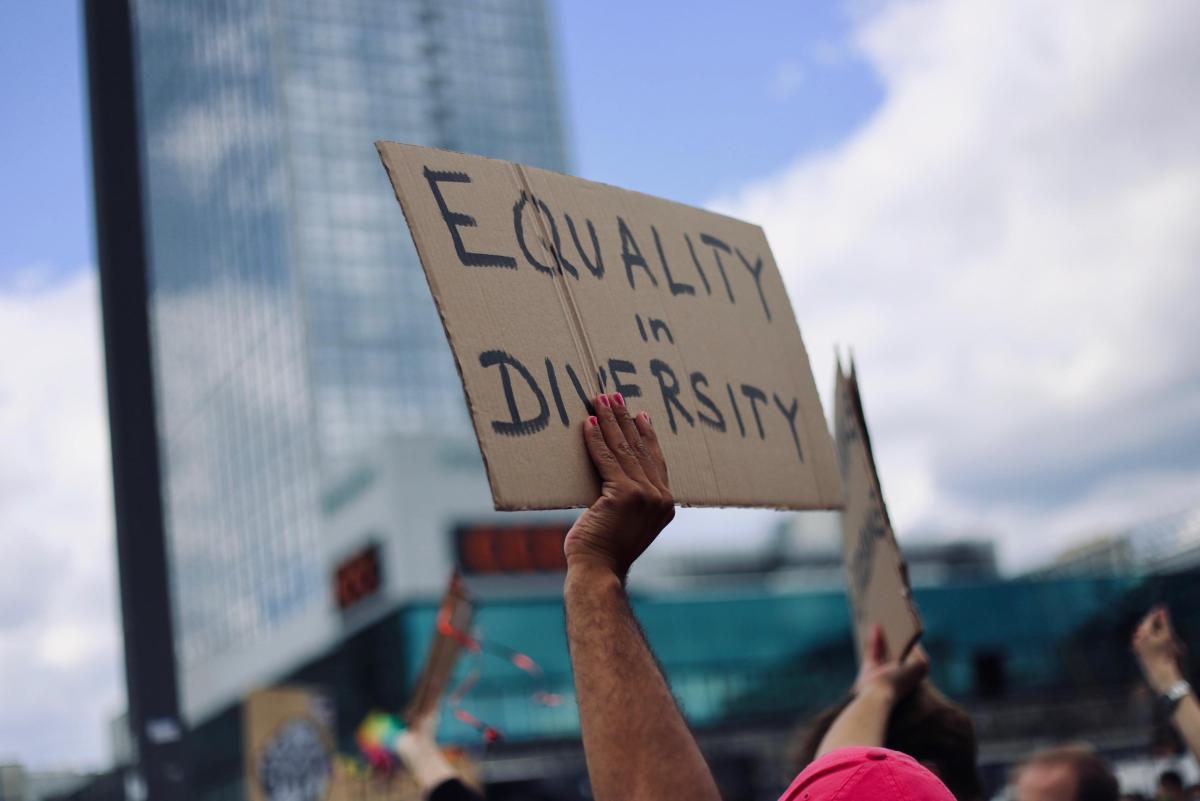 Someone holding up an Equality is Diversity sign