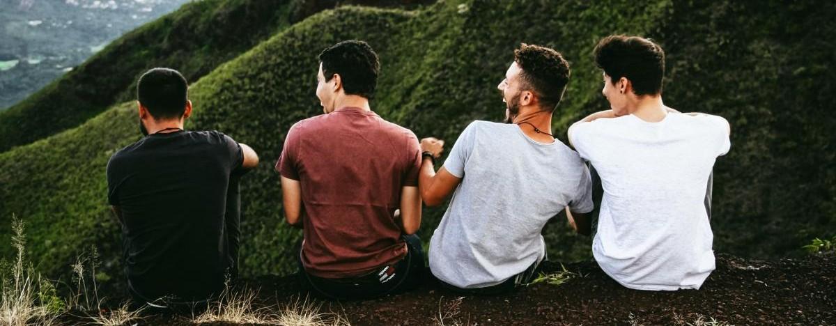 Four men sitting on a mountain