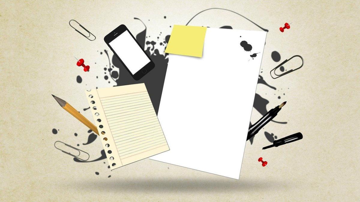 a busy image of paper, mobile phone & writing