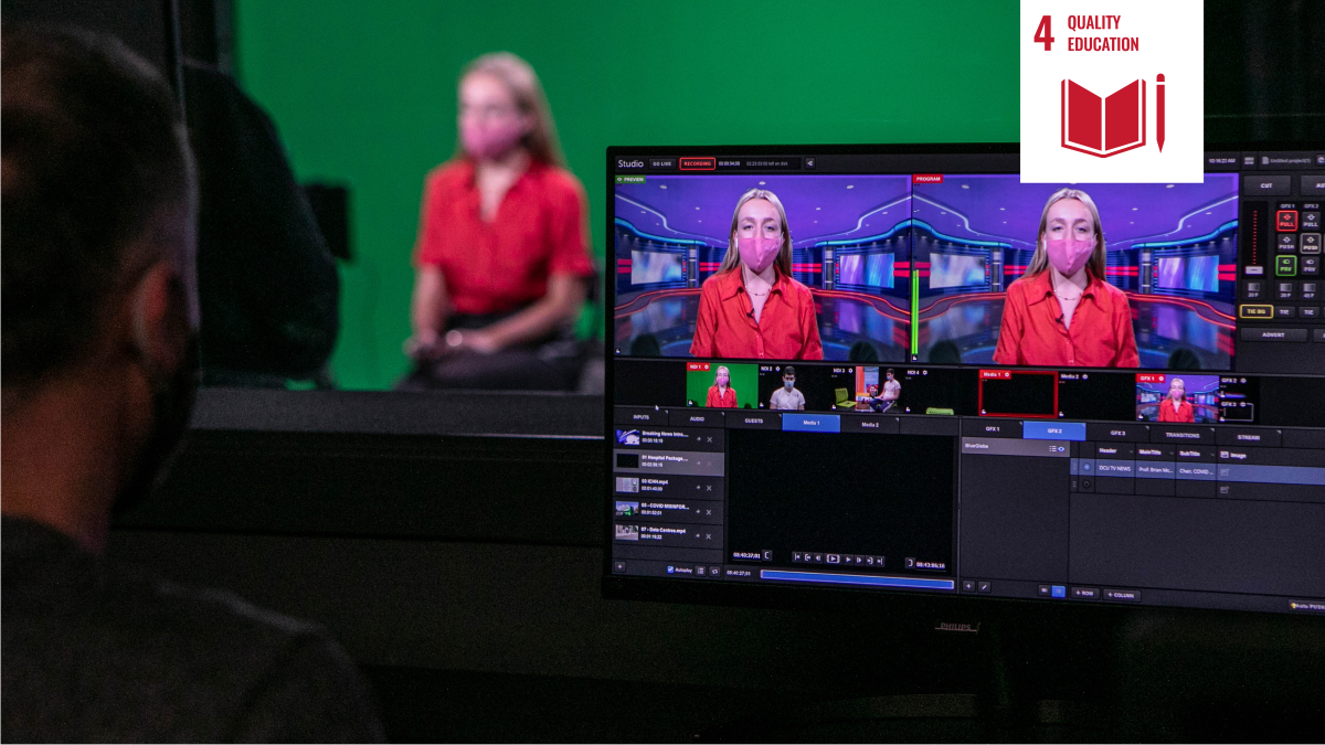 Shows woman wearing facemask appearing on a monitor in television news studio with white icon signifying UN Sustainable Development goal four