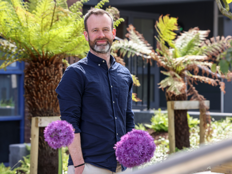 Shows Dr Jimmy O'Keeffe posing amongst plants on DCU's Glasnevin campus