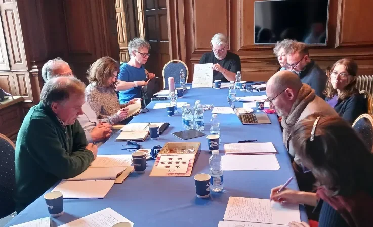 Shows delegates working on papers