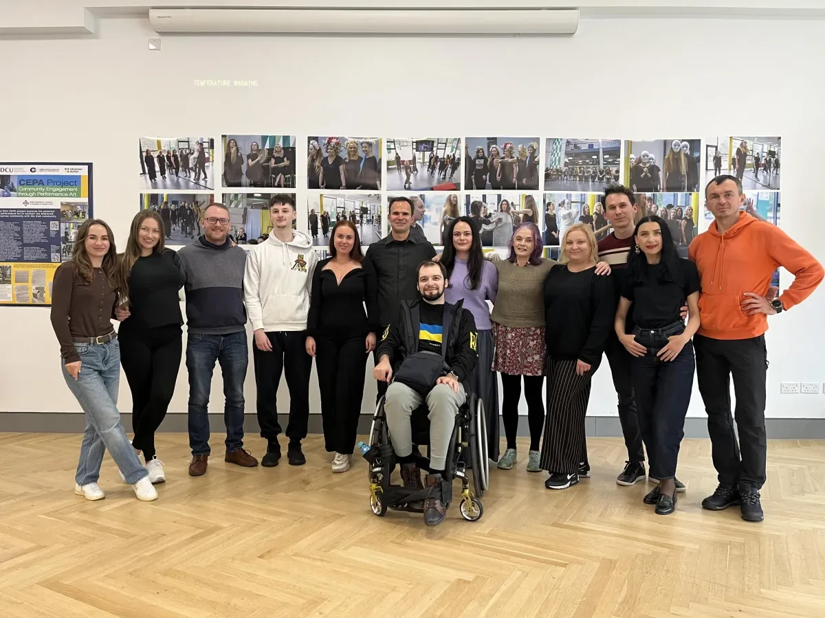Shows members of the CEPA project group with performers at photo exhibition event