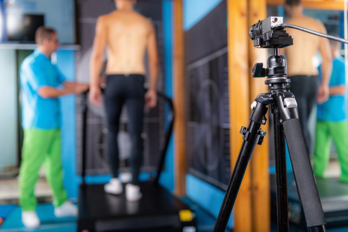 Shows man undergoing gait analysis in a clinical setting