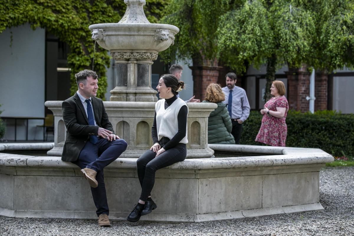 People chatting around fountain, St Patrick's Campus, DCU