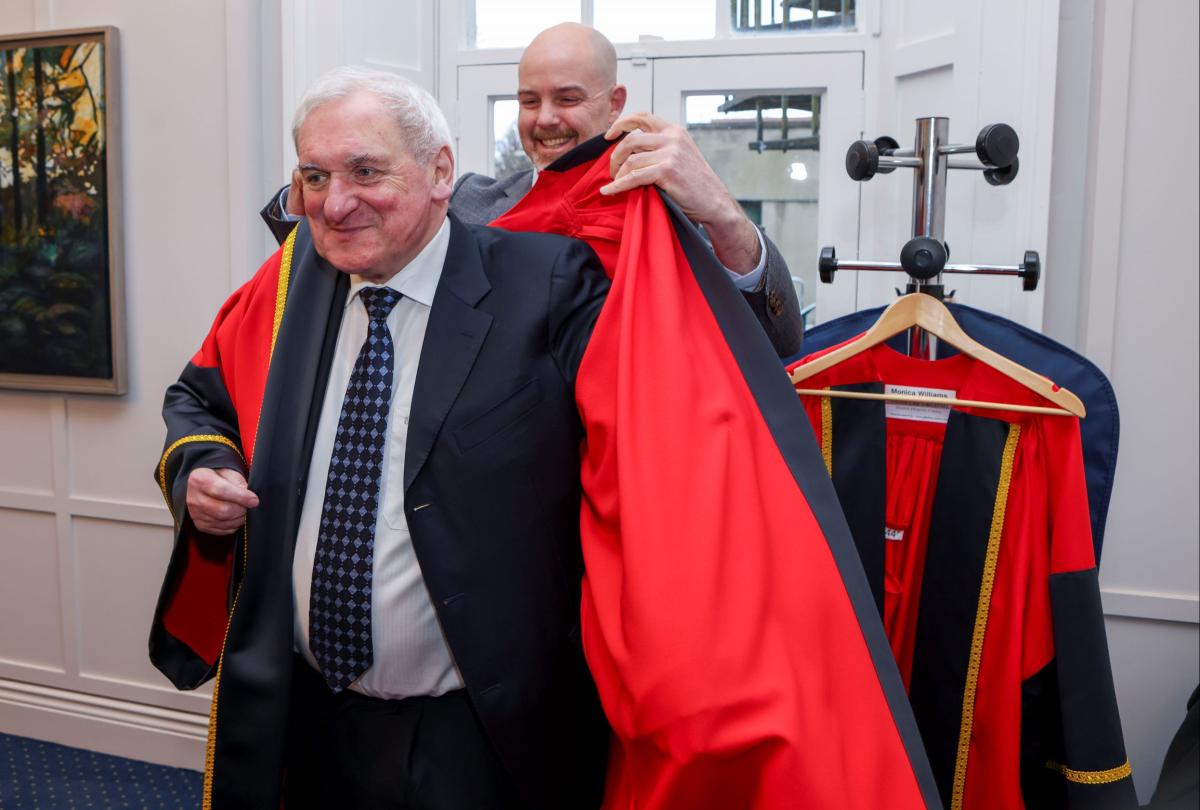 Bertie Ahern donning his robe ahead of his honorary conferring