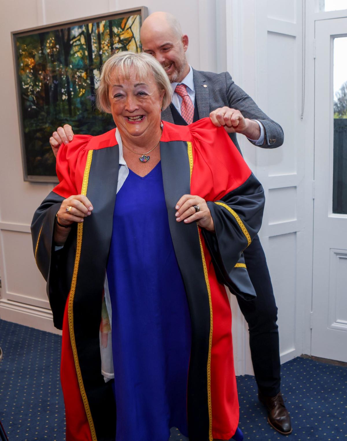 Prof Monica McWilliams donning her robe ahead of her honorary conferring