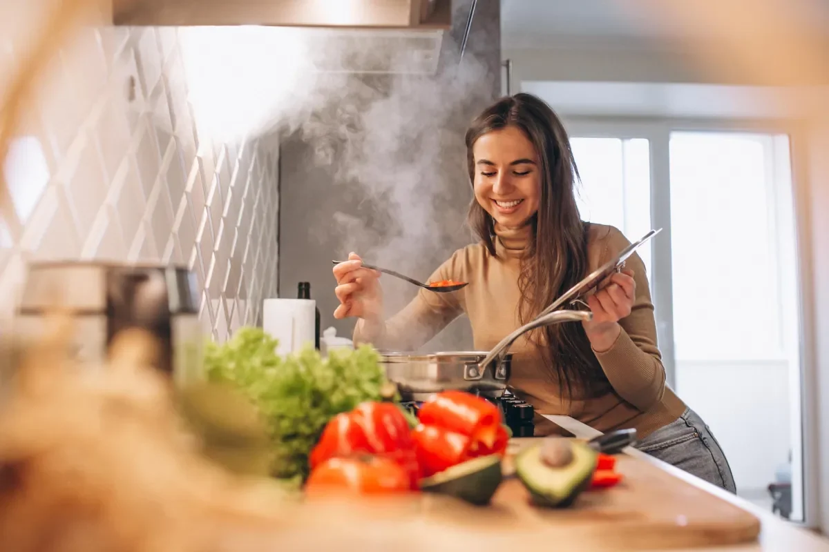 a woman cooking and smiling