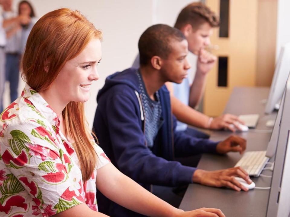 Three students working at a desk