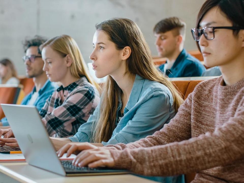 Students in class working on laptops