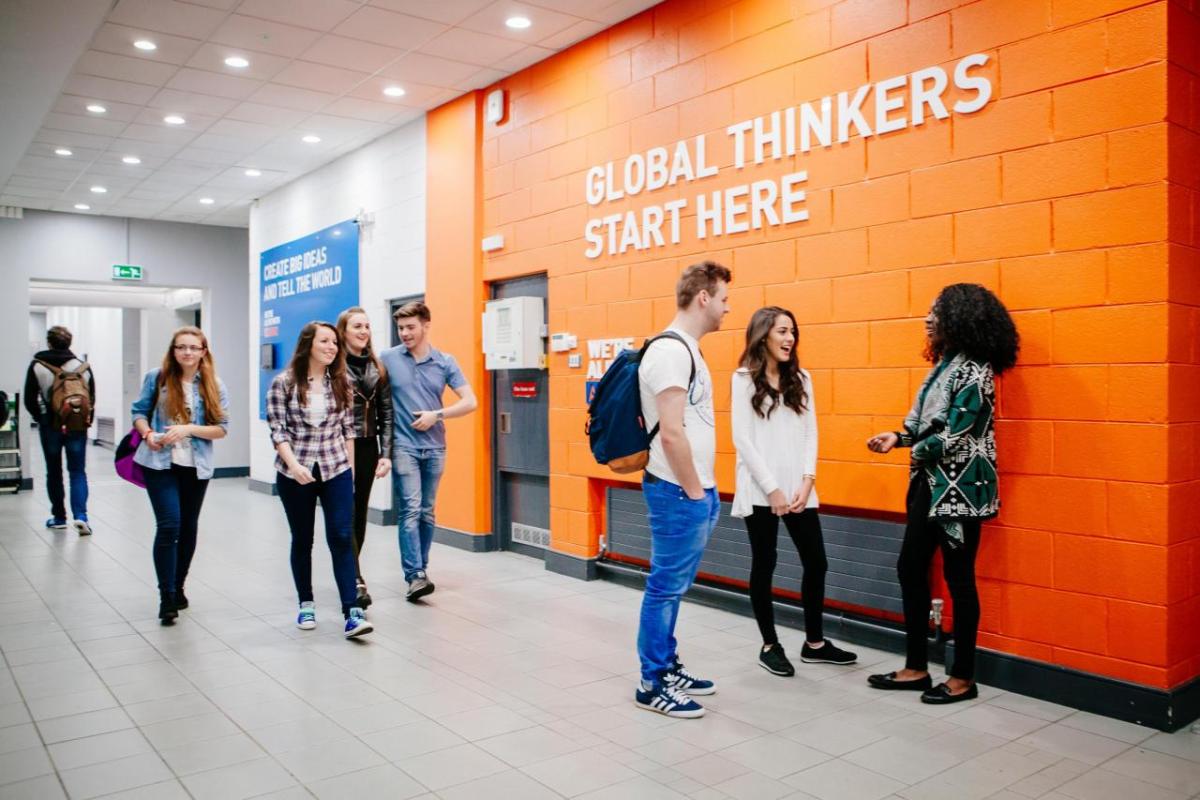 Students walking and talking in a corridor