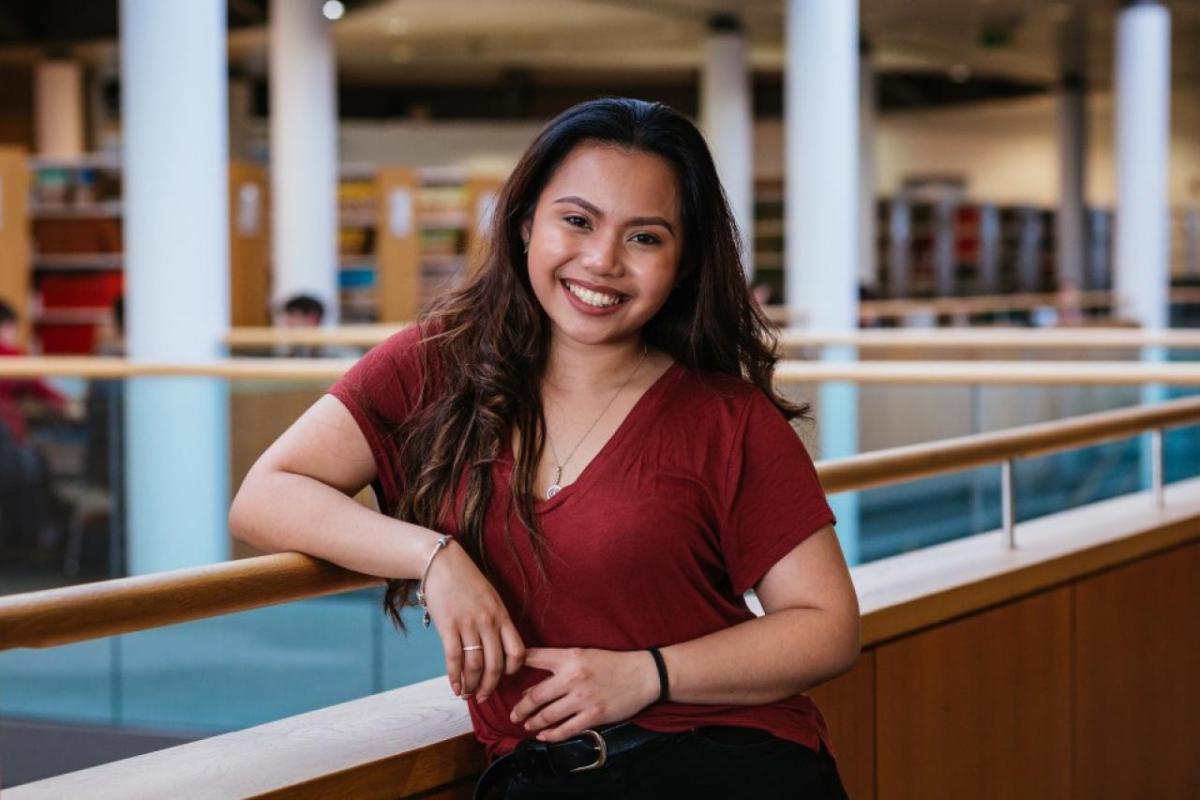 One student standing in a library