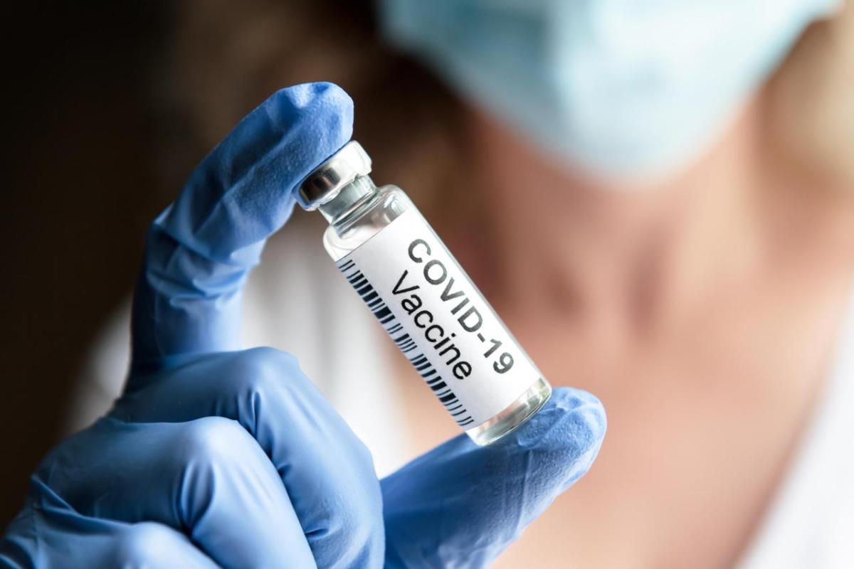 Health professional holding a covid-19 vaccine