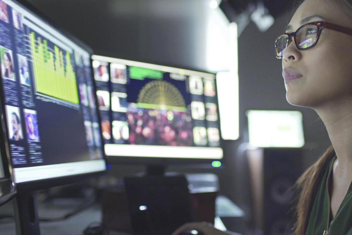 one student looking at multiple computer screens