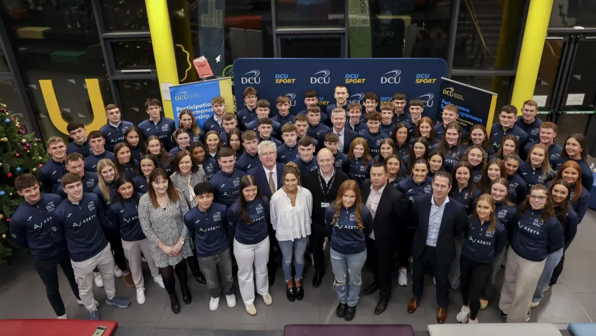 The sport scholars standing in a large group.