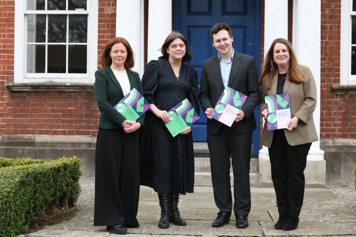 Prof Anne Looney, Prof Mary Rose Sweeney, Adam Harris and Dr Sinéad McNally pose with copies of the Autism Schools report.
