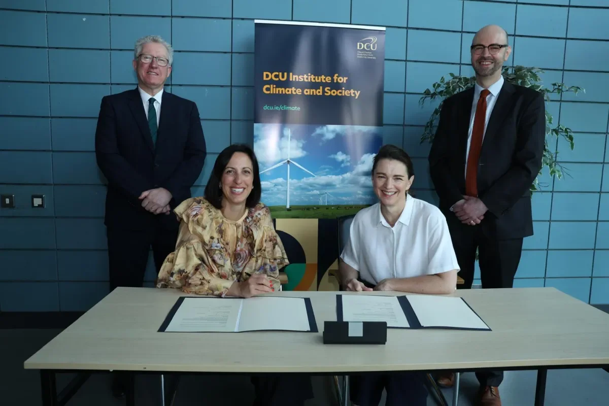 Representatives of DCU and Front Line Defenders sign the MOU.