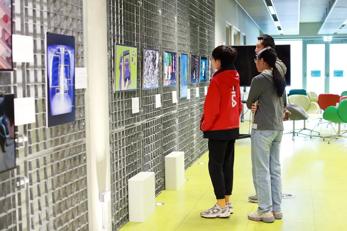 Three people looking at artwork