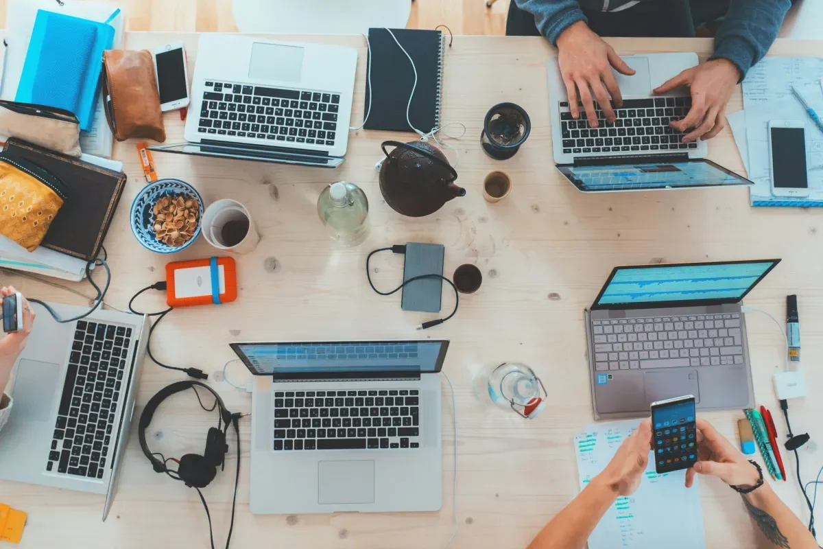 a range of technologies on a table from laptops to phones