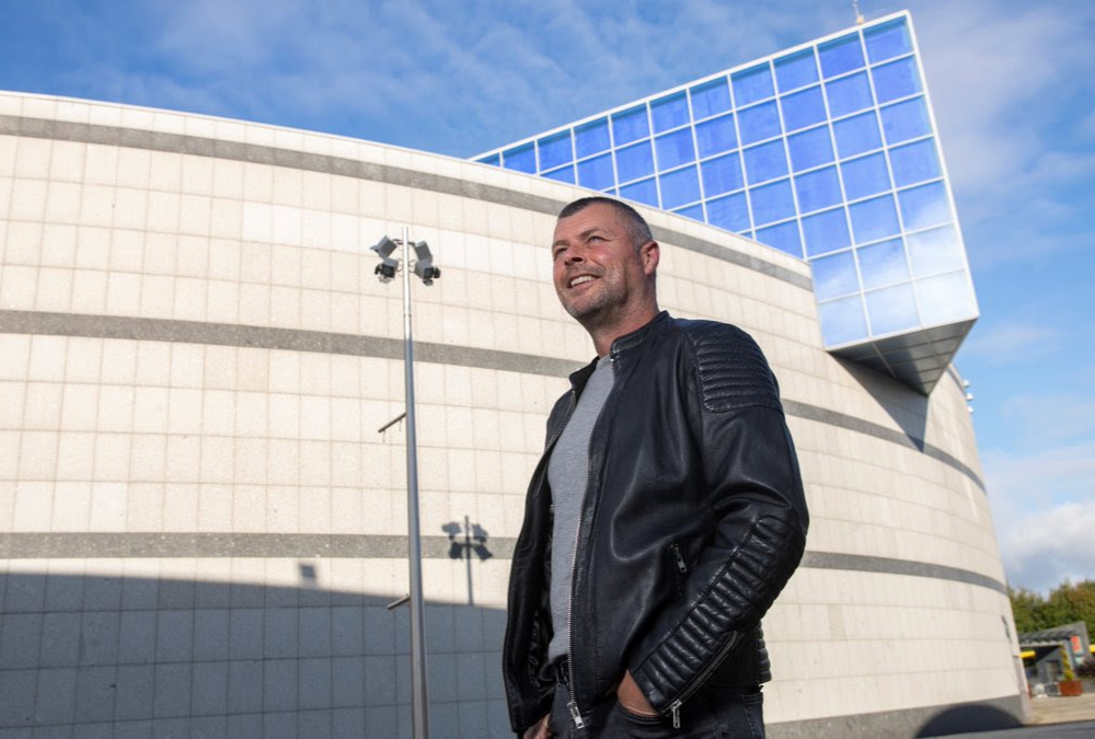 man standing outside campus building