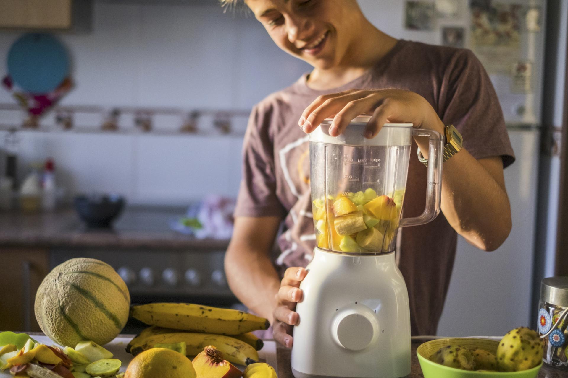 male student blending a smoothie