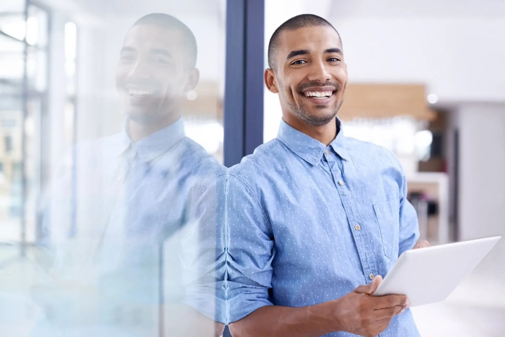 man leaning against a door smiling