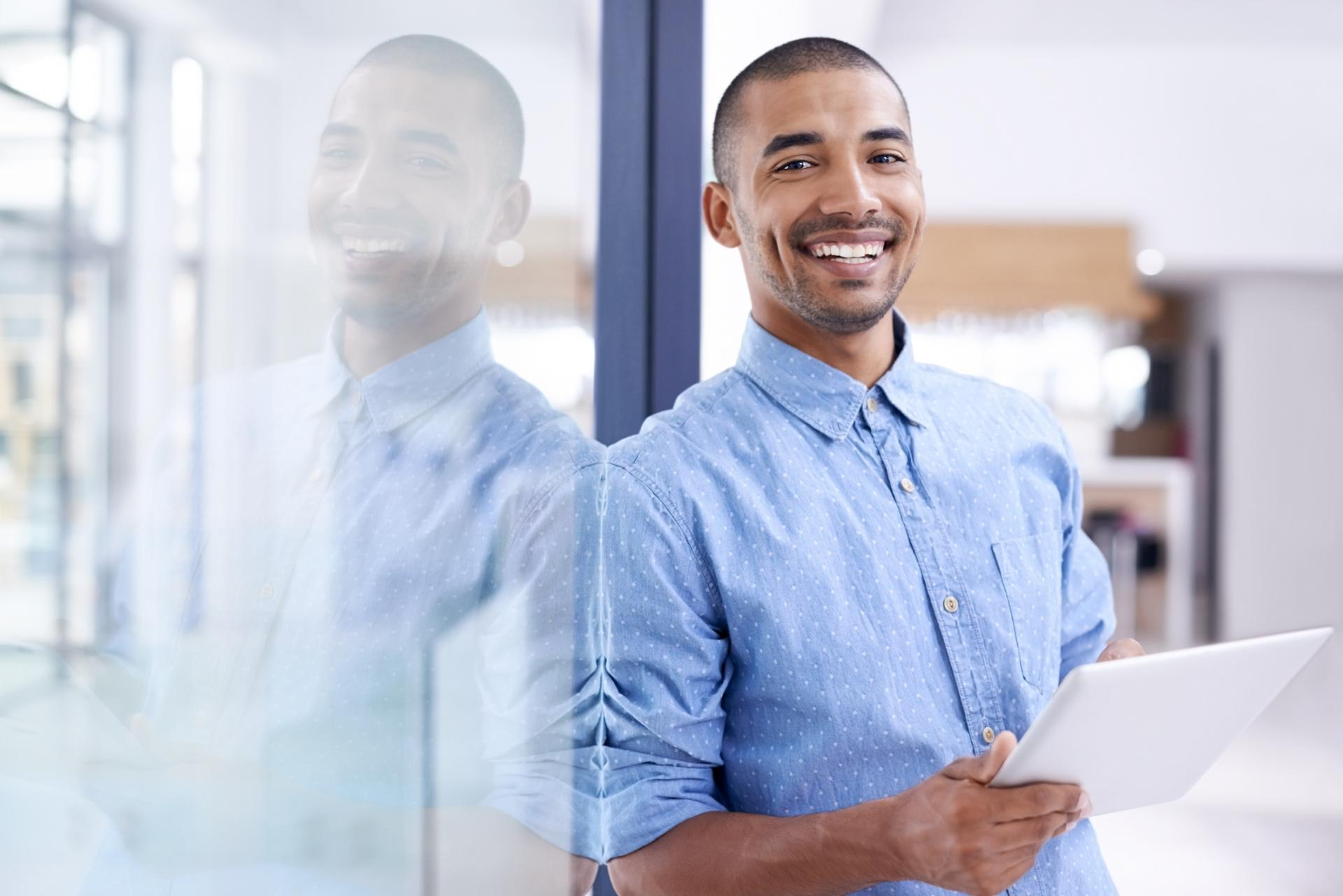 man leaning against a door smiling