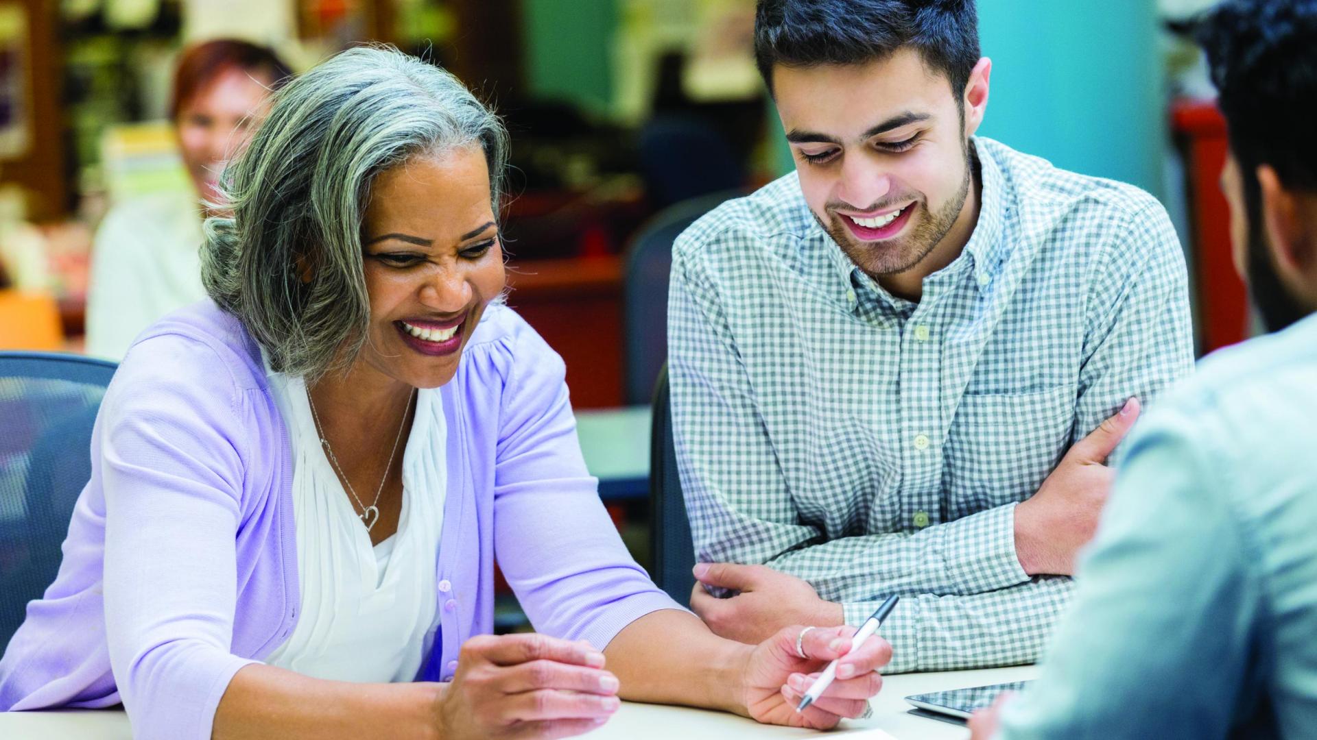 Older lady showing younger man something on paper