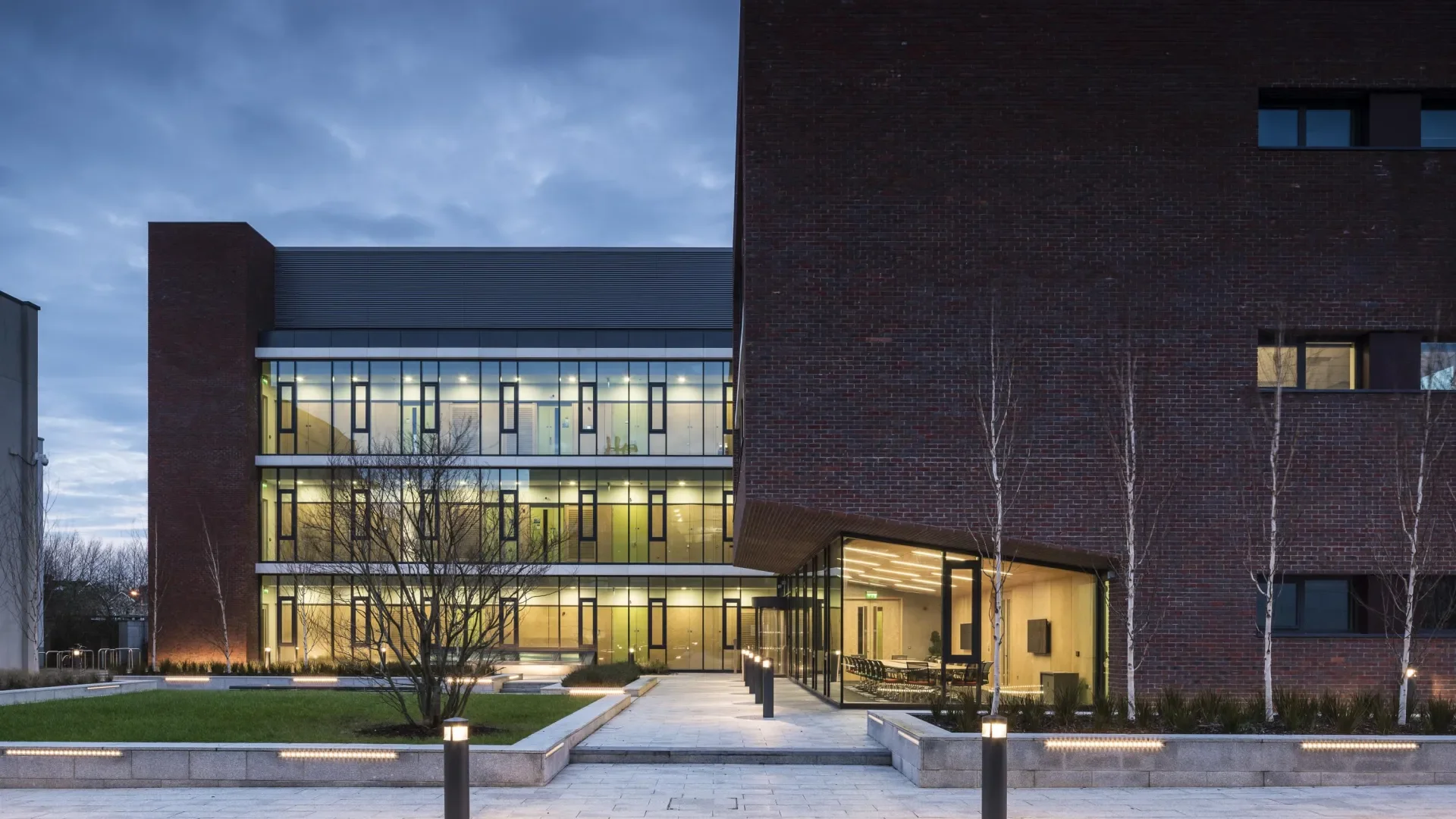 The NRF building at night with internal lights on