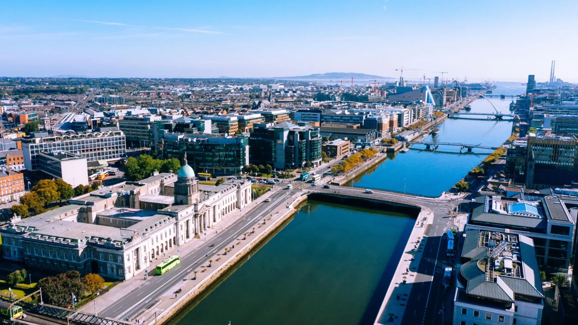 Shows aerial view of dublin city centre with the Liffey in foreground