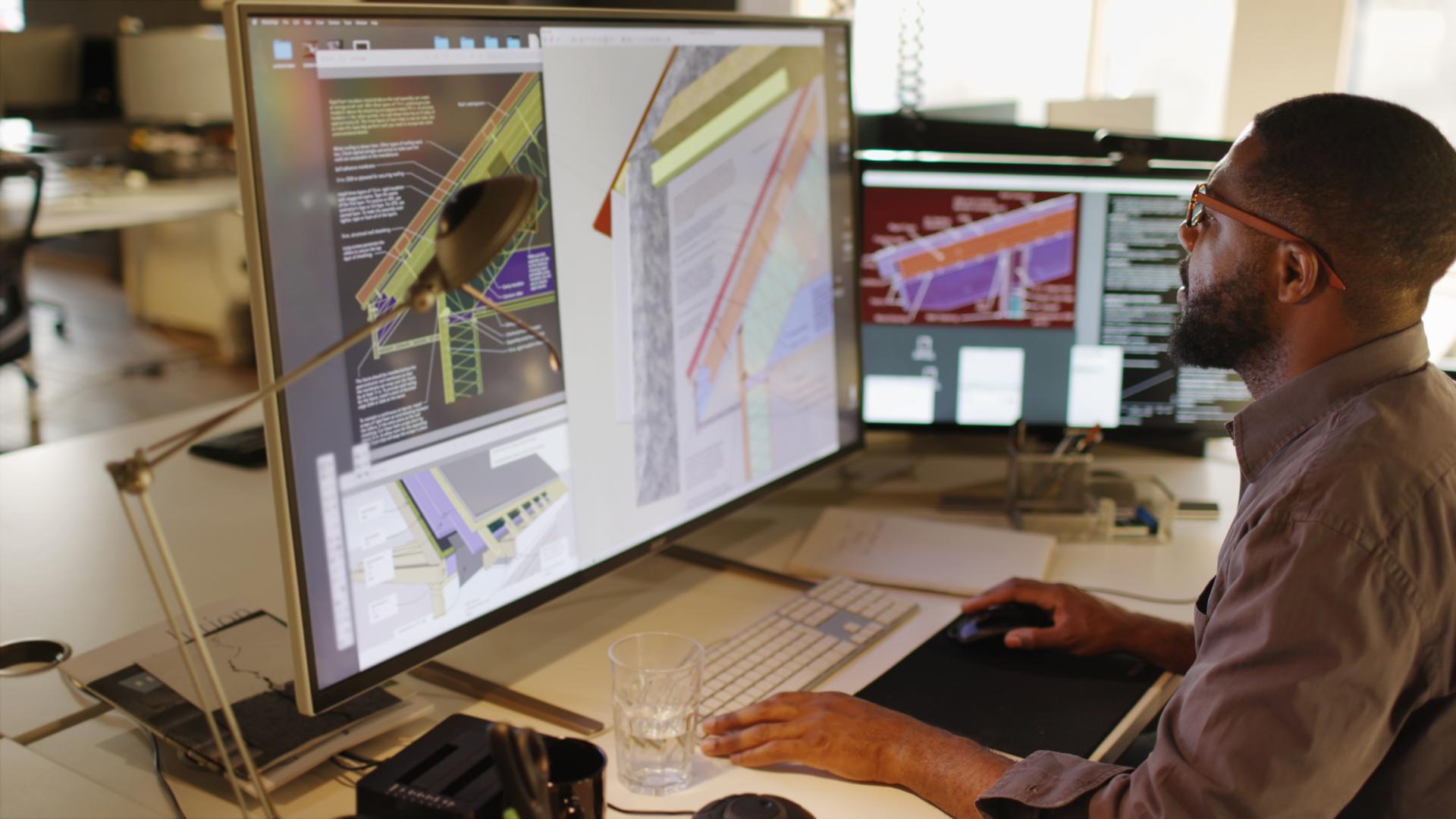 Shows man working at computer