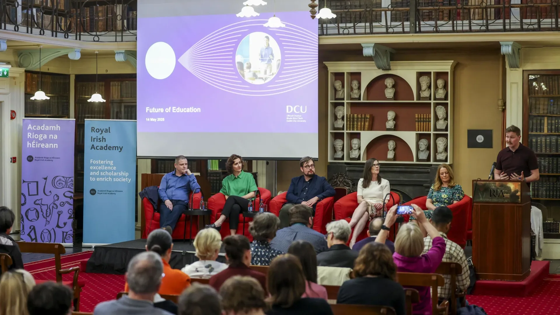 Shows DCU Research Impact speakers on stage at the Royal Irish Academy