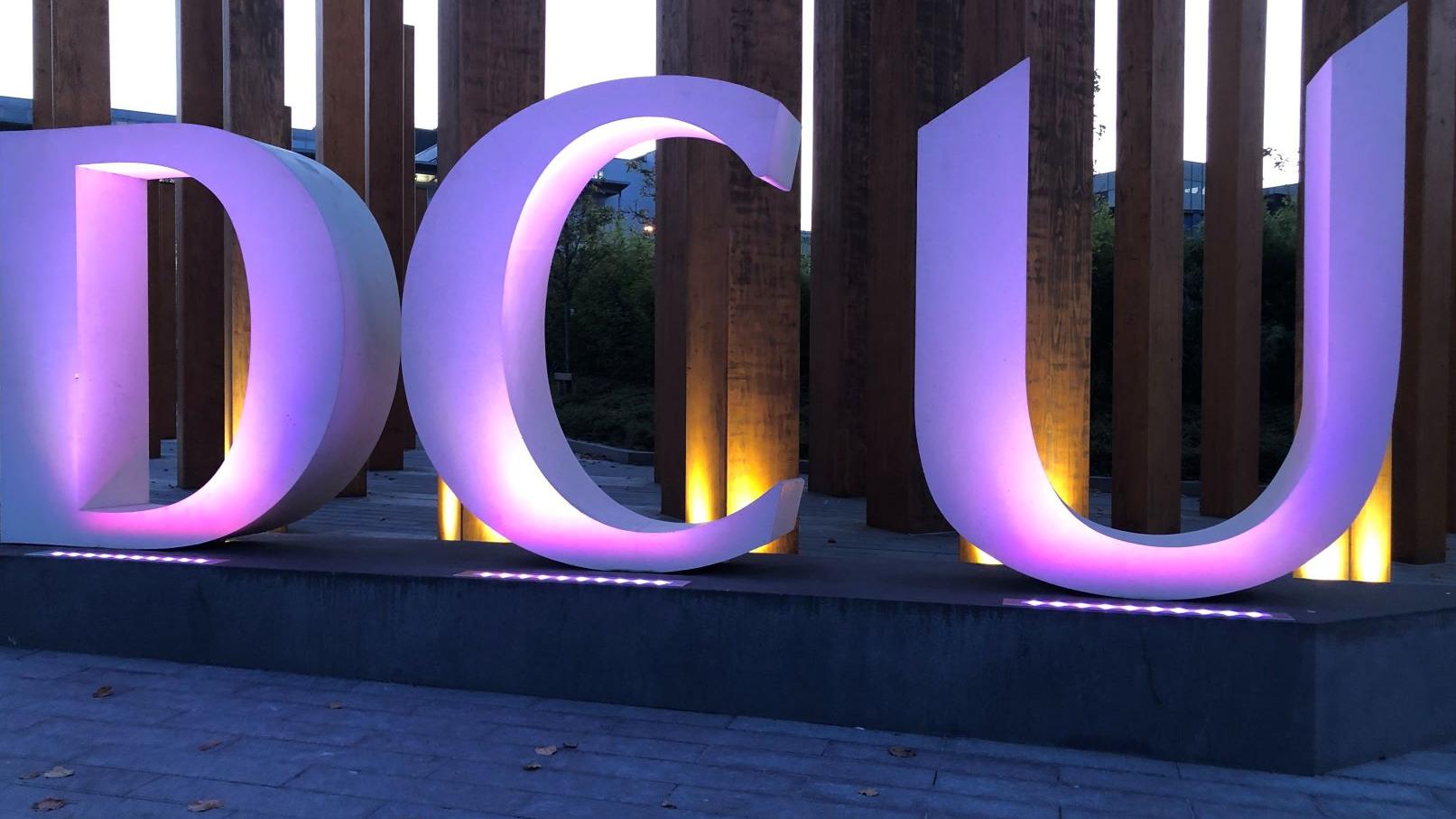 A DCU sign lit by purple lights. 70 buildings and landmarks across Ireland turned purple for Intersex Solidarity Day on 8 November 2020.