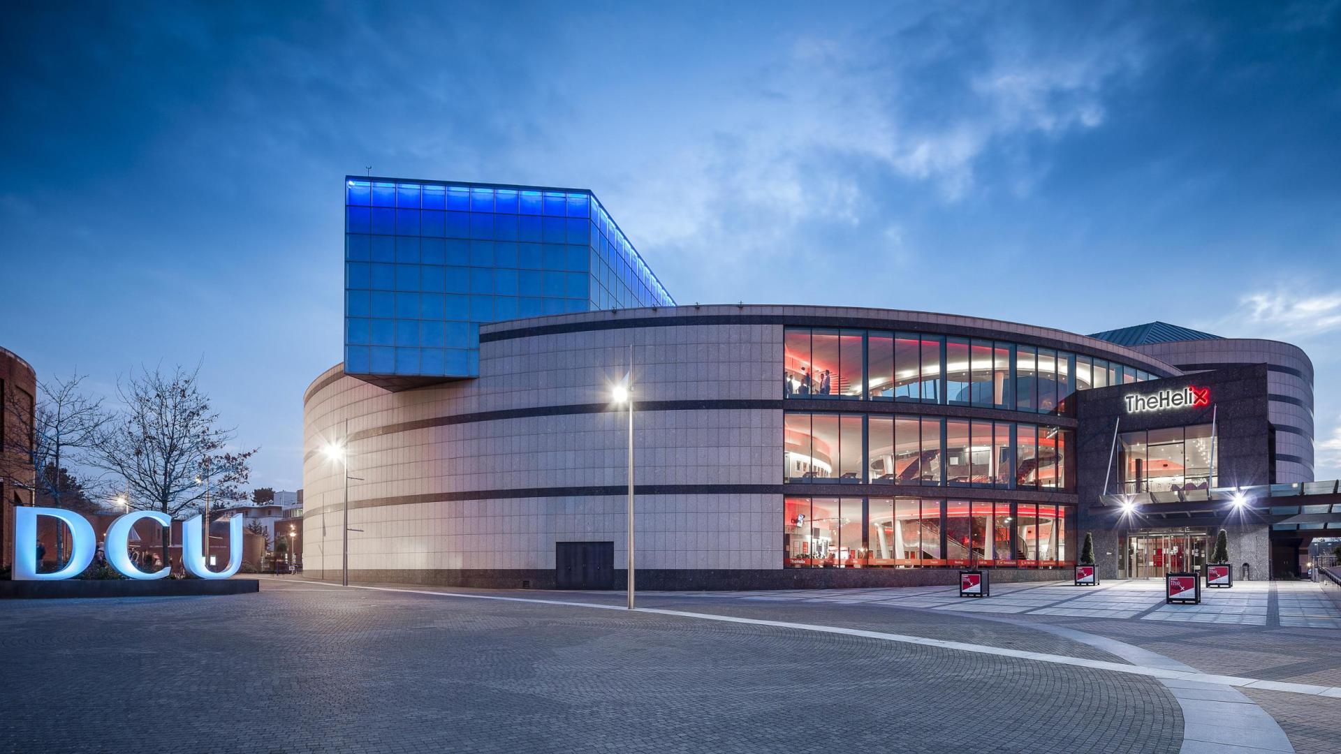 photo of DCU letters' sculpture and the  Helix at dusk