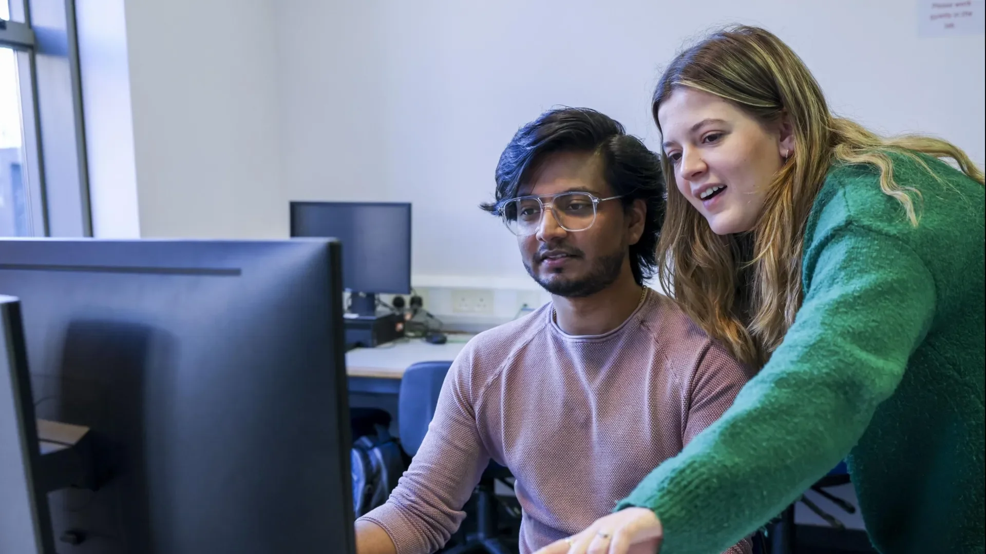 Students work on computer together