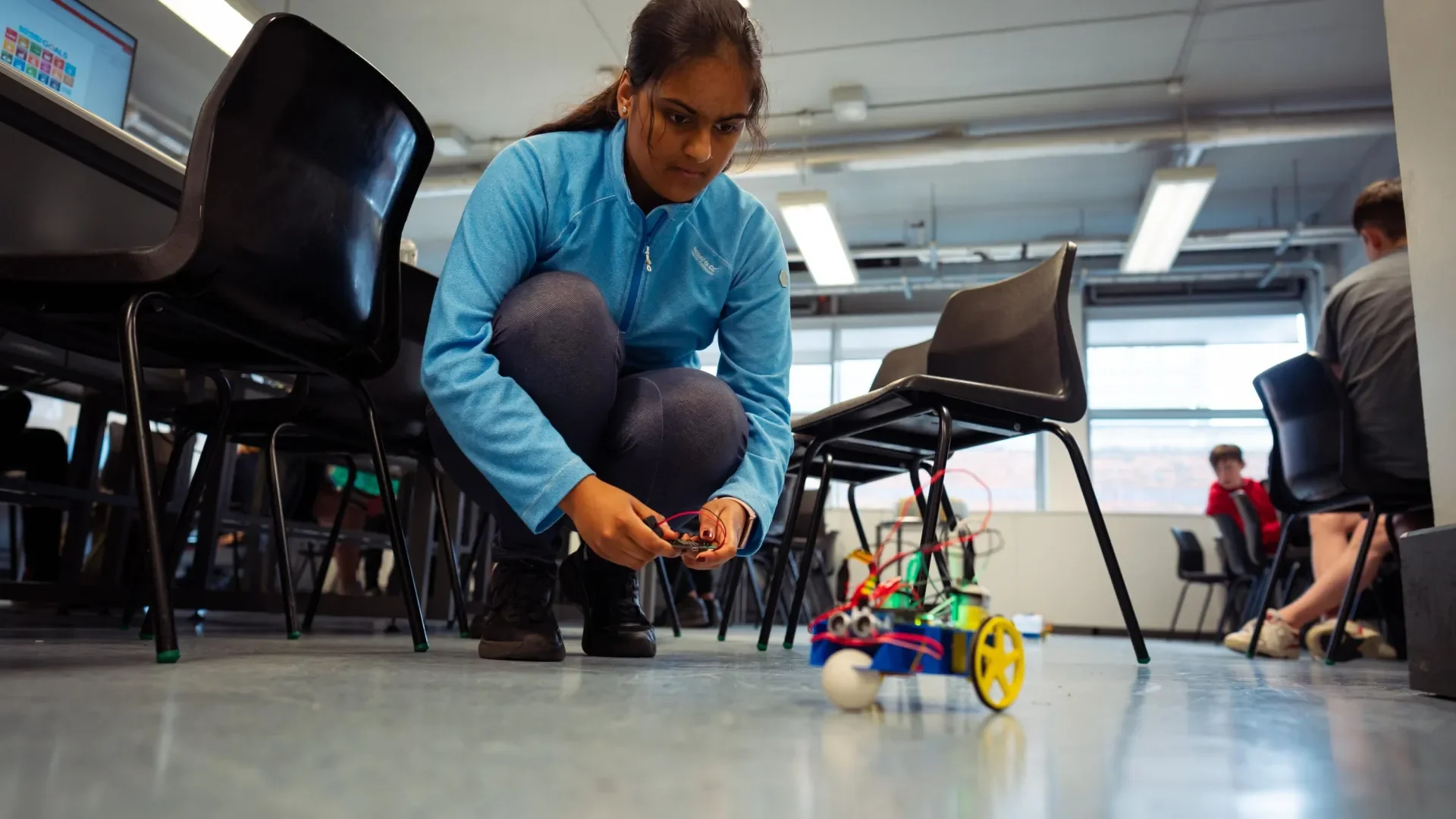 Student plays with autonomous vehicle