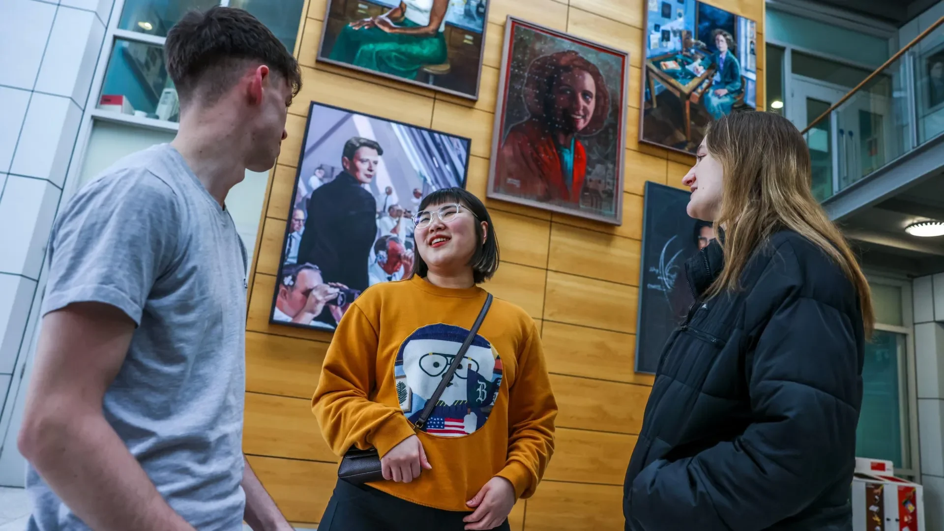 Students chat in the foyer of the Stokes Building