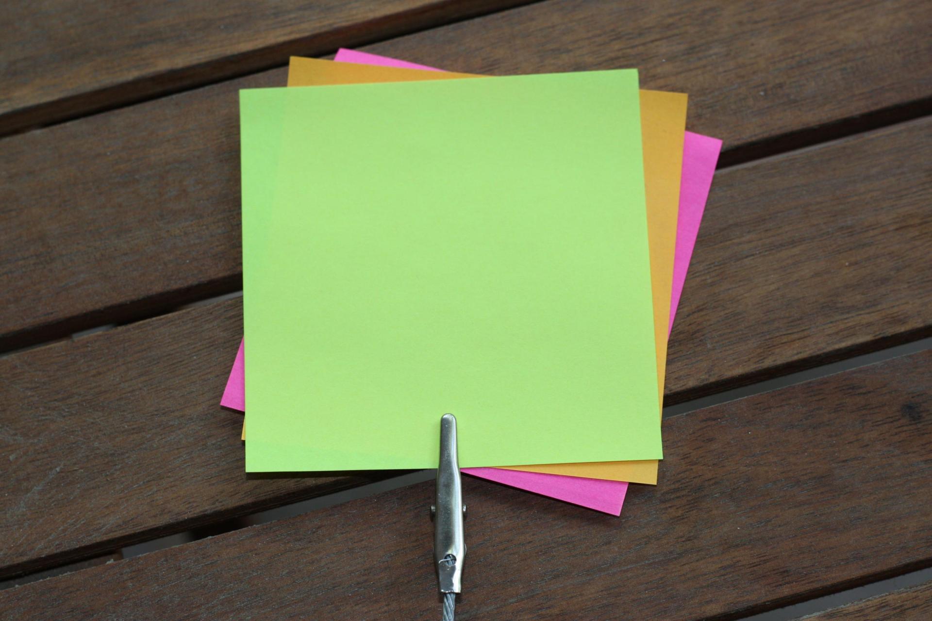 Several coloured post-it notes attached to a clip