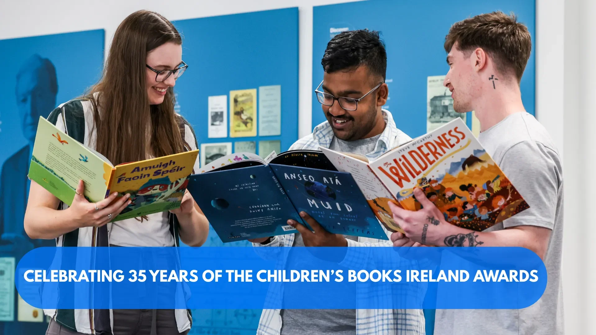 Image of three people reading books from the Children's Books Ireland Collection at DCU Special Collections & Archives
