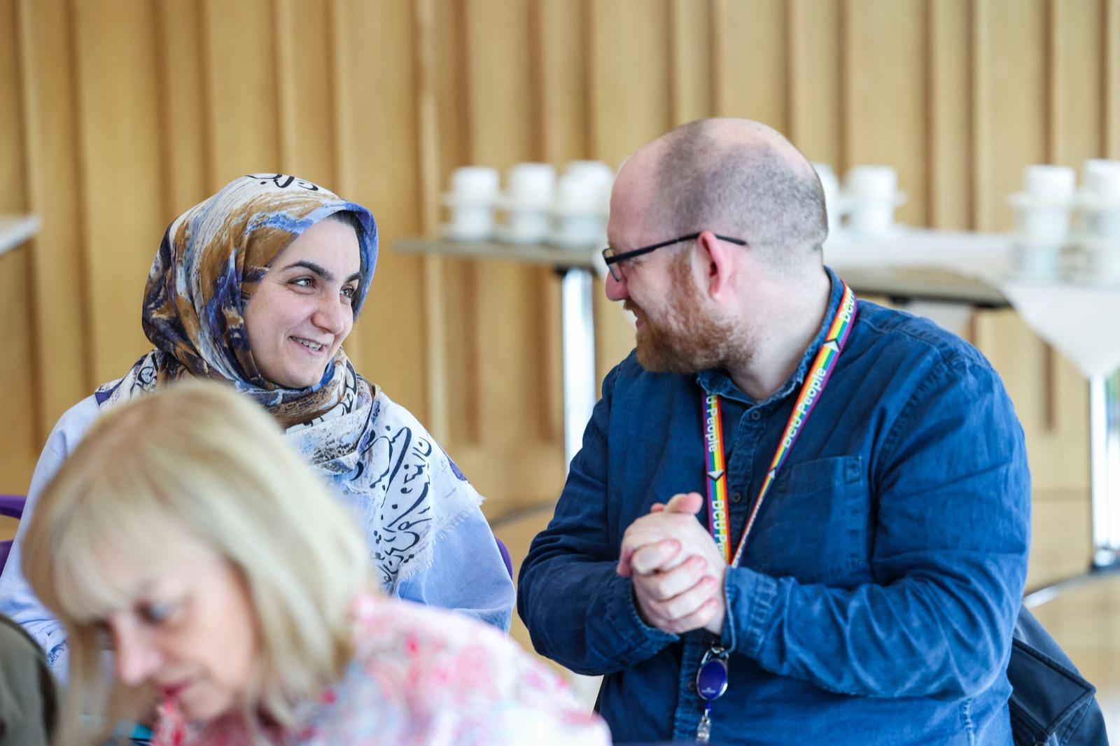 Two staff members talking to each other at the launch of Care & Connect