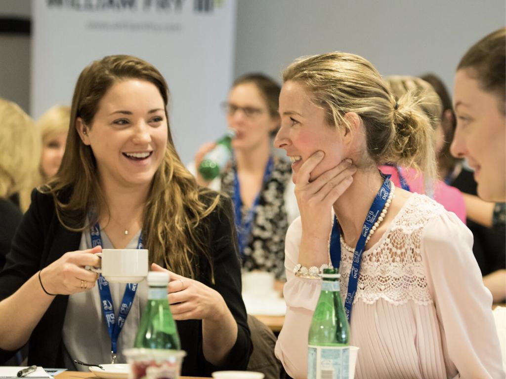 2 business women enjoying conference