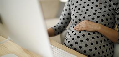 Pregnant woman working at PC