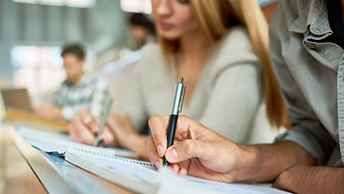 students writing in a lecturer room