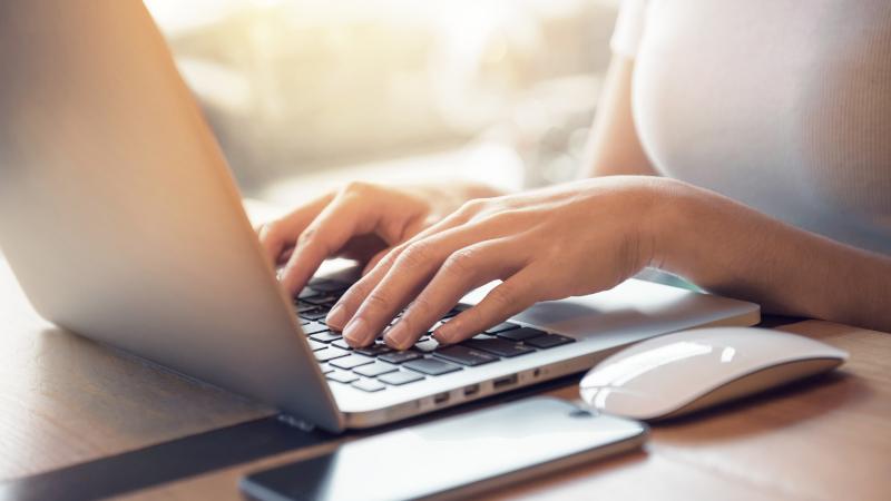 Women typing on Laptop