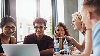 Group laughing while working