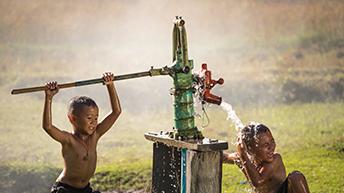 Children at a water pump