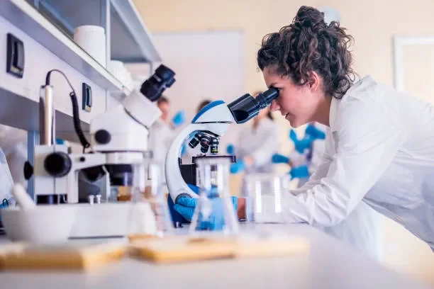 Stock IMage of woman looking in microscope