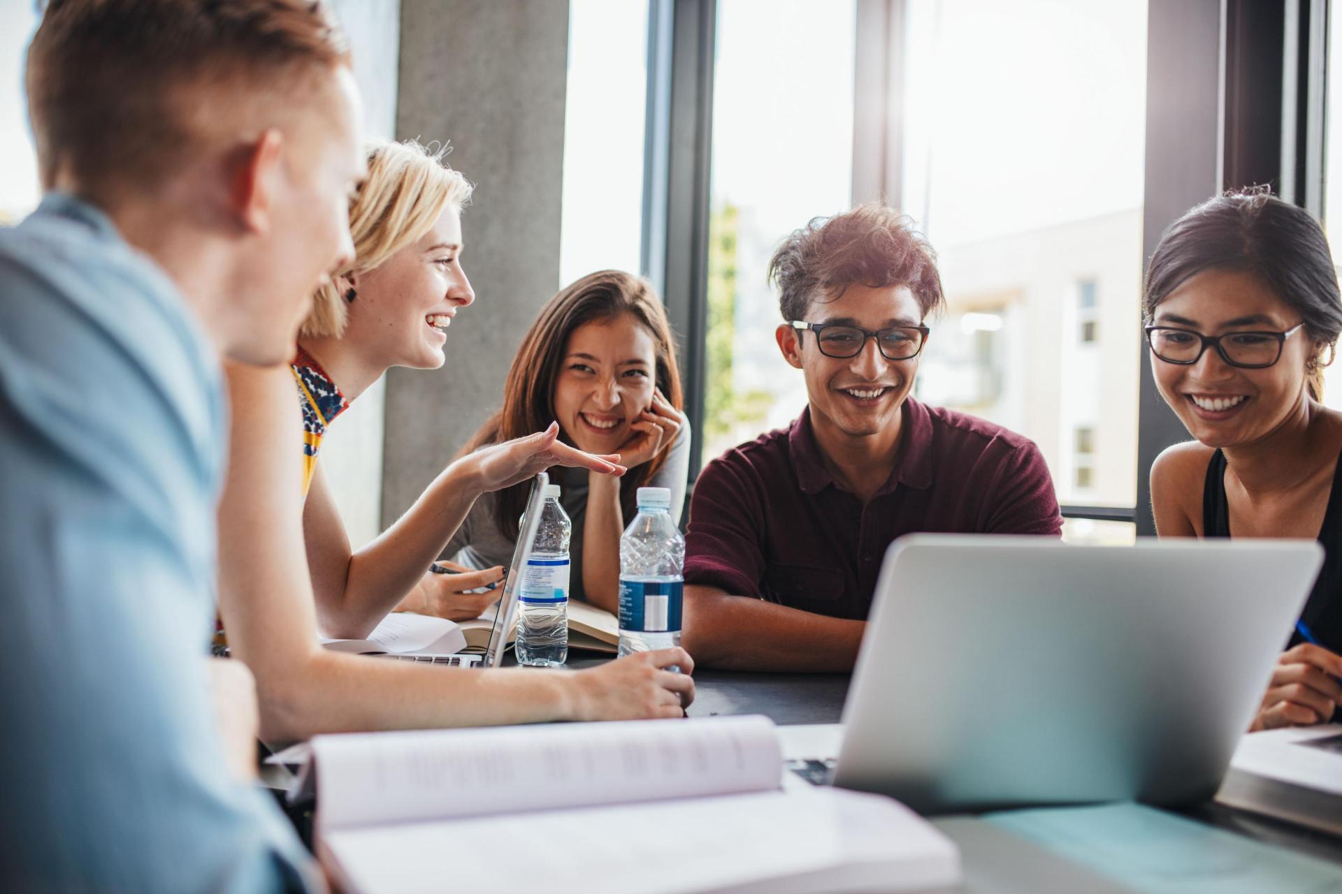 Five students studying at a table 